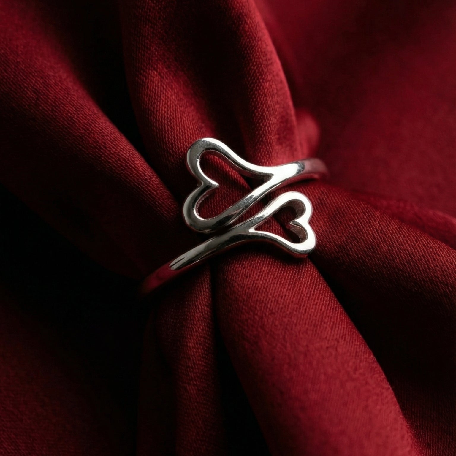 Silver ring on a red fabric background