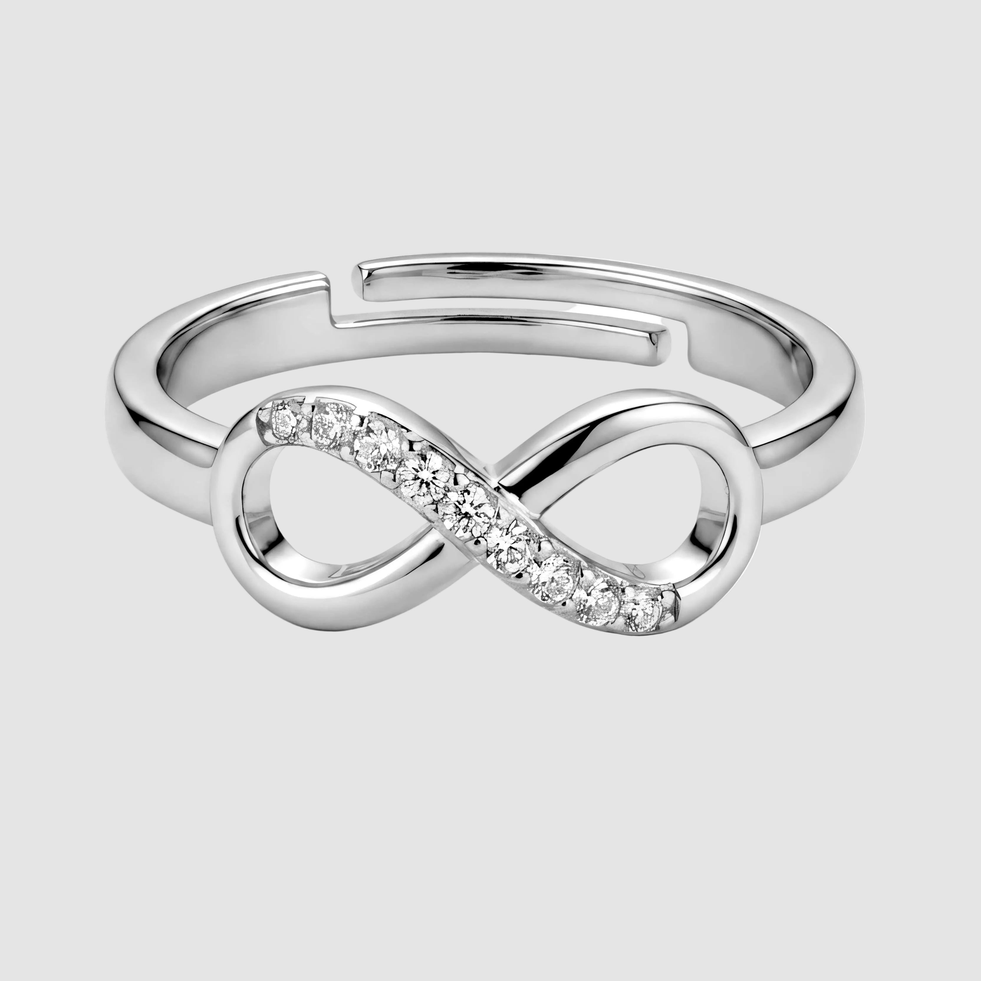 Silver ring with a heart design on a purple fabric background