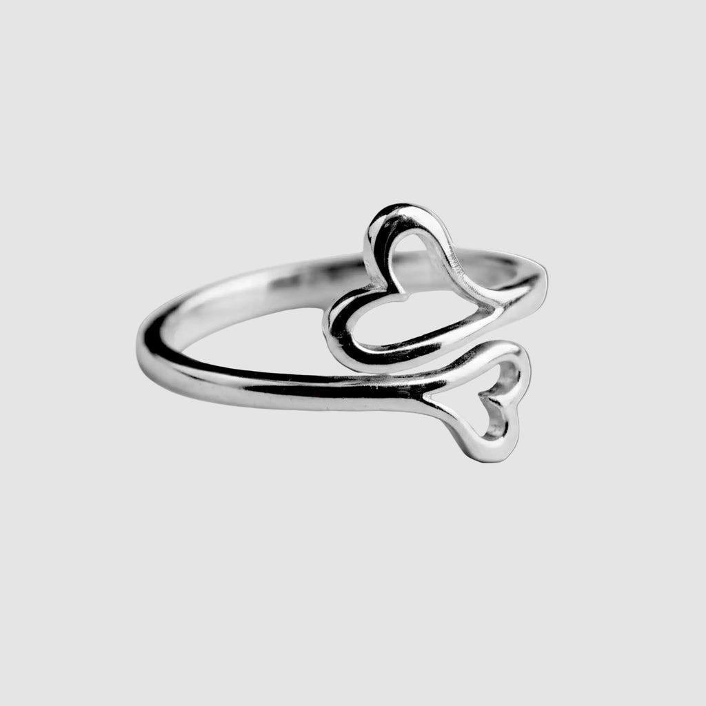 Silver ring with a heart design on a white background