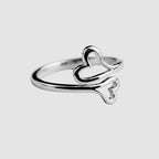 Silver ring with a heart design on a white background