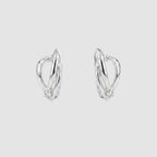 A pair of silver-toned huggie hoop earrings with a small cluster of clear stones at the bottom of each earring, shown on a plain white background.